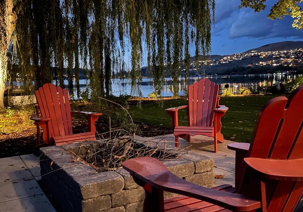 fire place with red chairs lake front