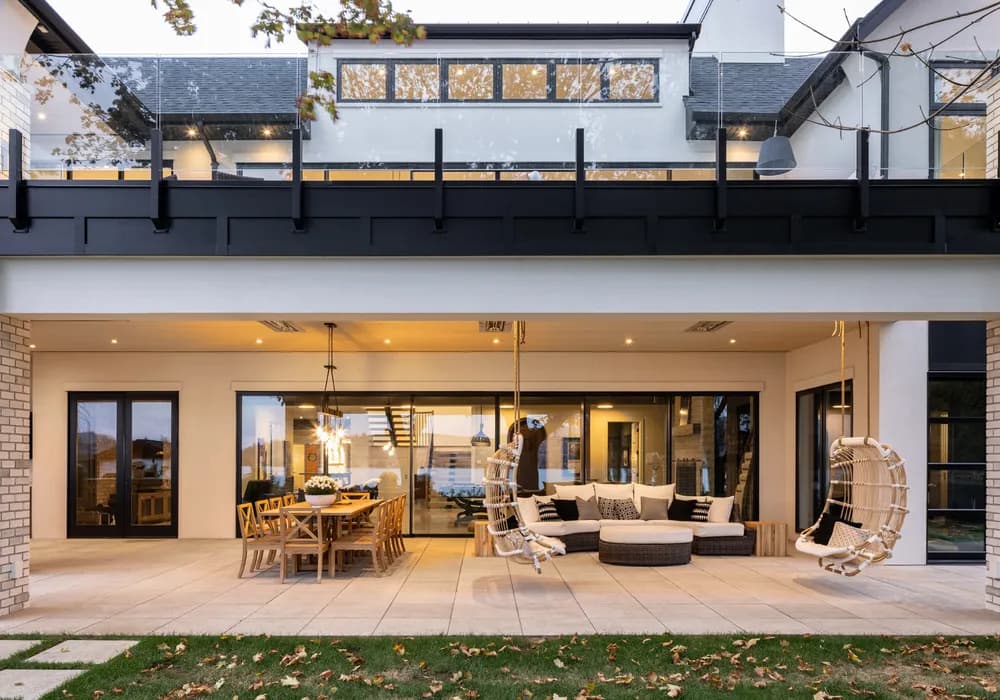 modern home with outdoor lihgting fixtures and a green lawn