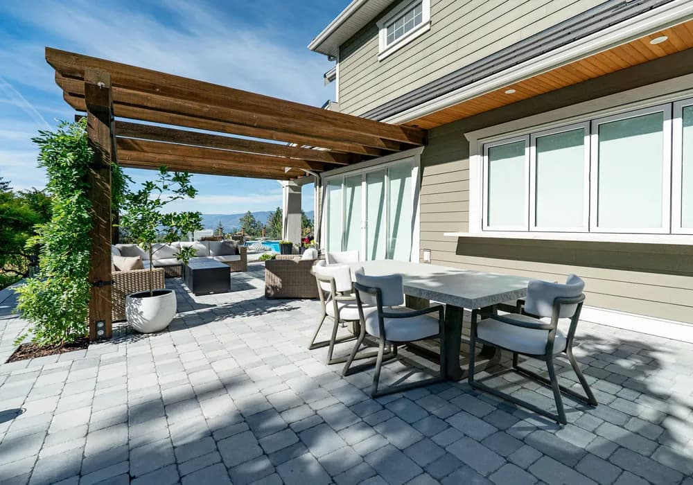 paver stones floor with pragola and vines