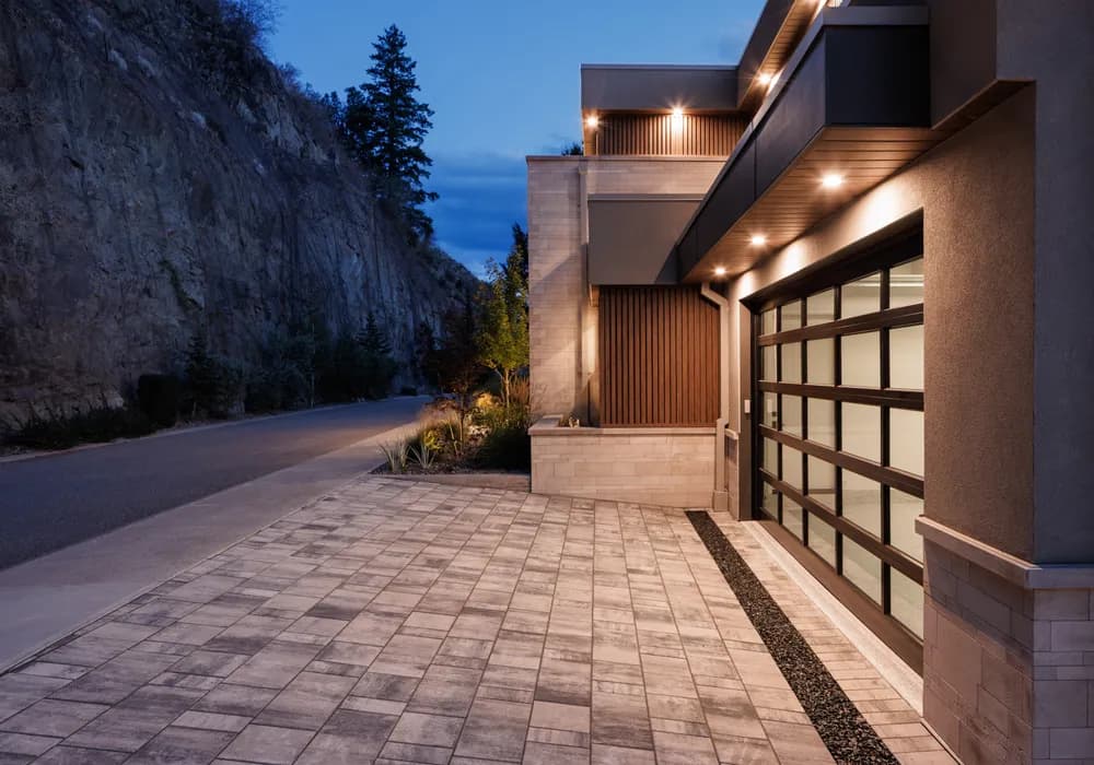 stone driveway and modern home night time lighting