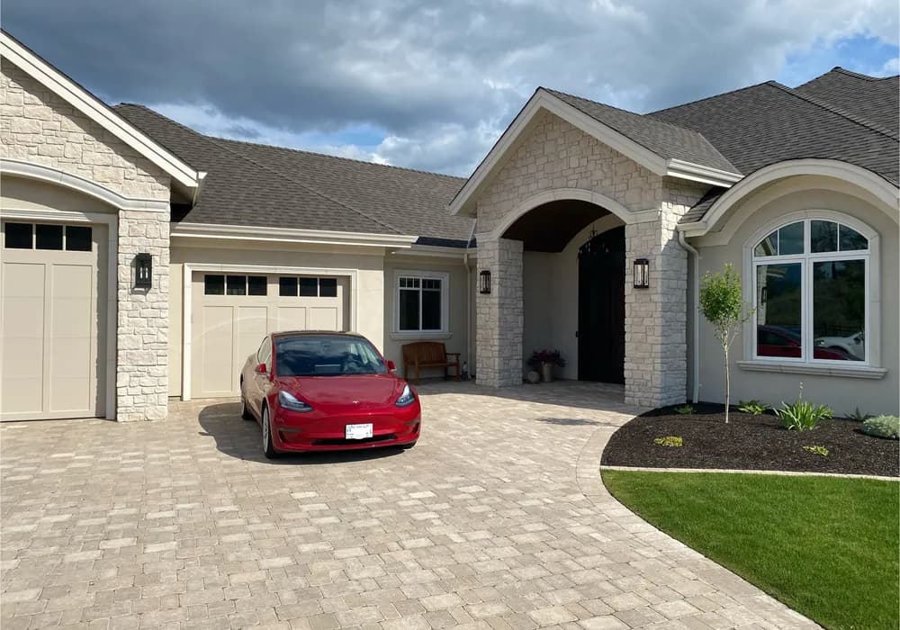 tesla with paver stone driveway