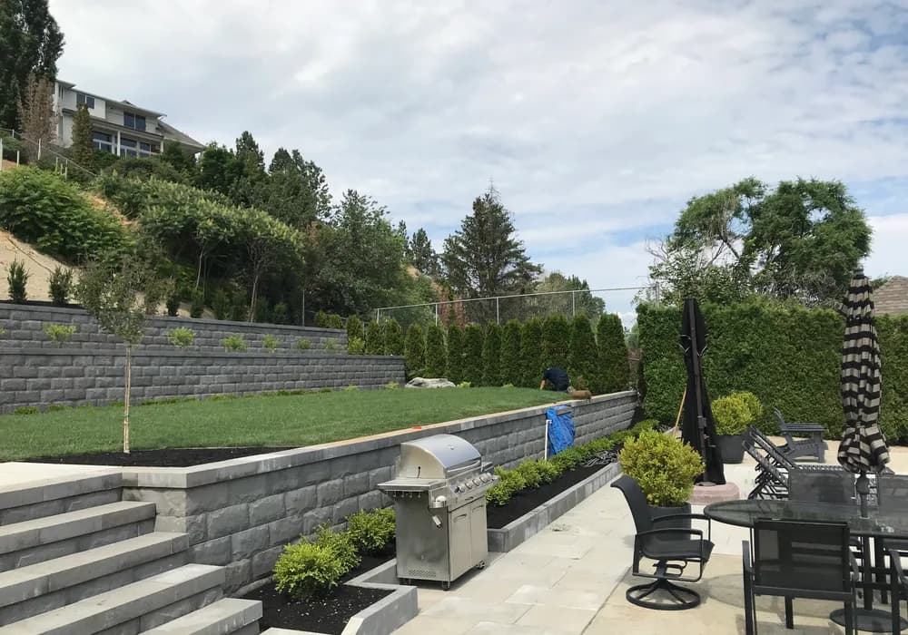 worker working with bbq retaining wall and steps