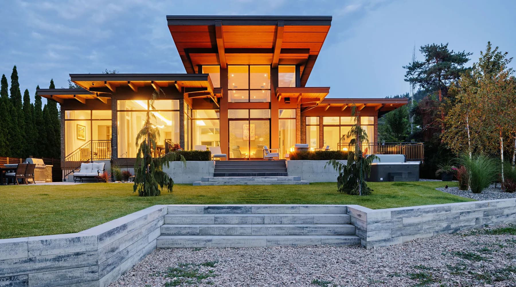 modern home with lawn retaining wall and stairs